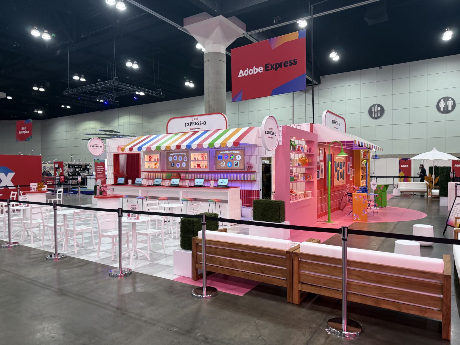 Large branded booth on a convention floor hosting live print programming