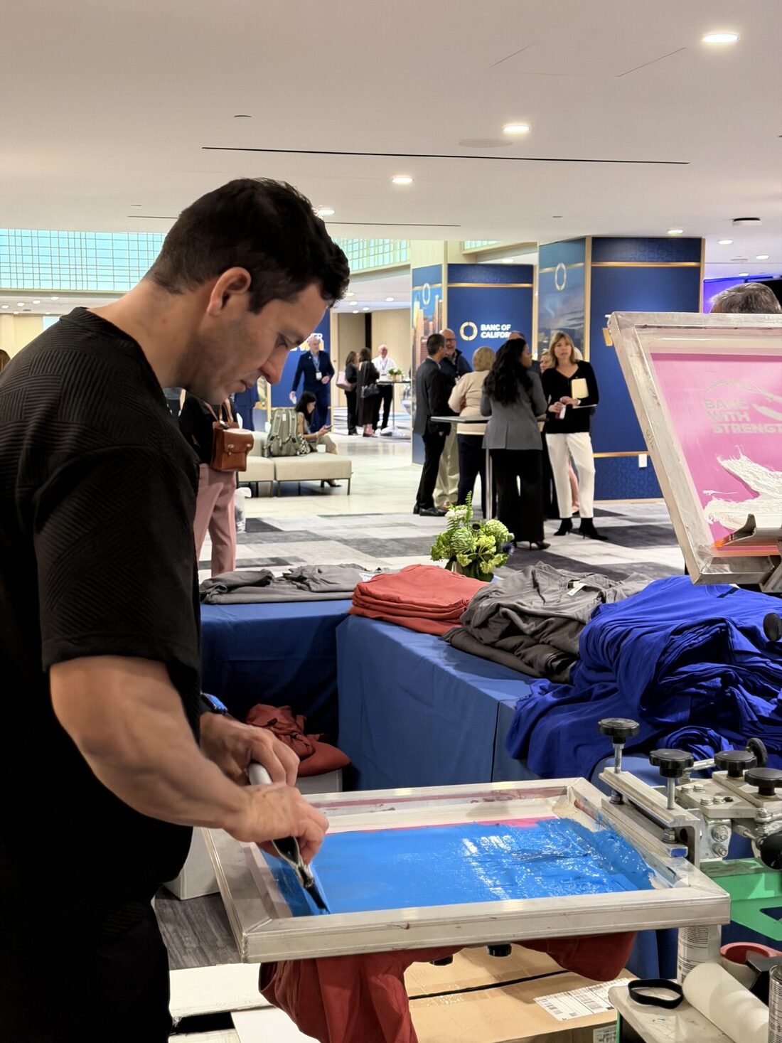 Printer pulling a fresh print at a trade show booth station